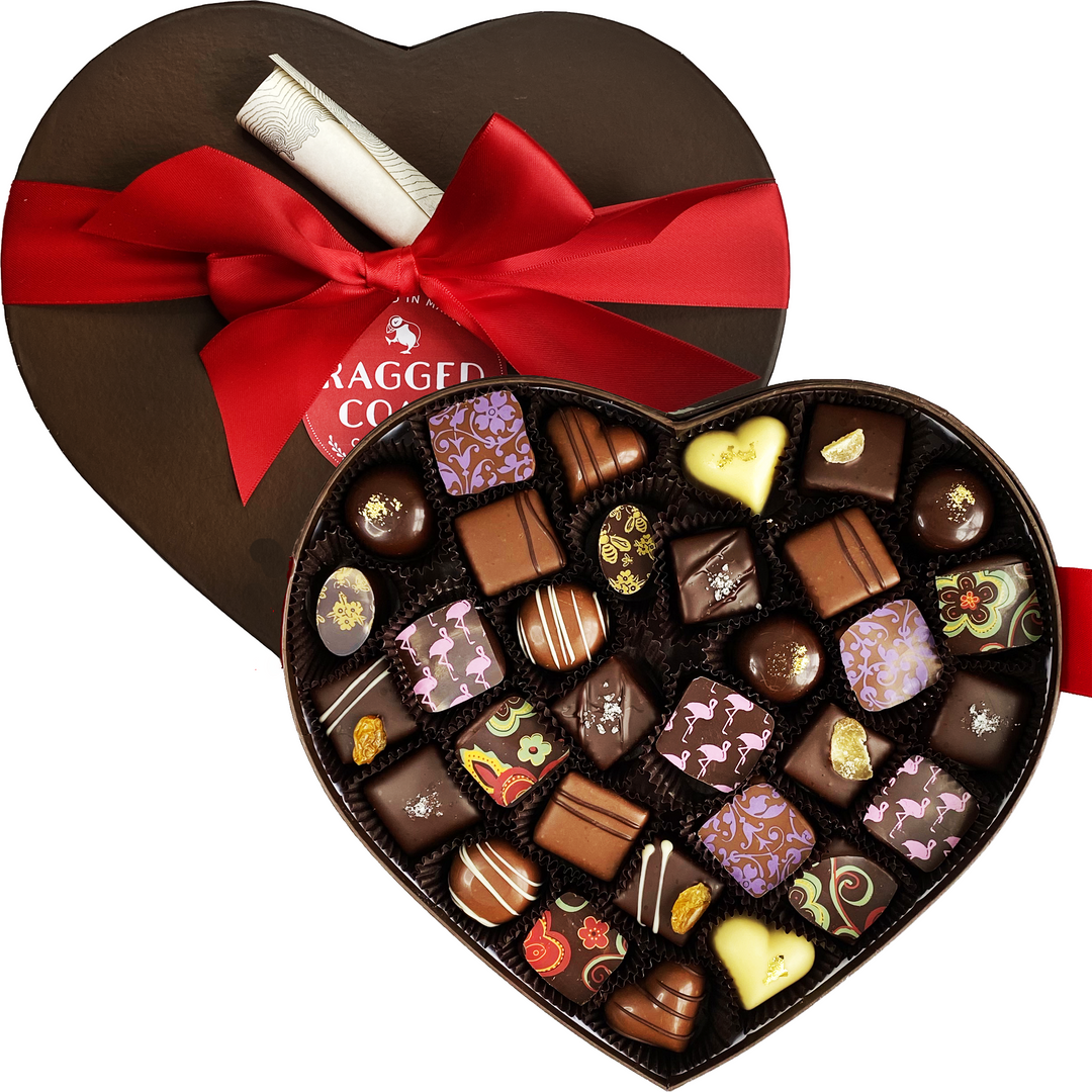 A heart-shaped box of assorted chocolates tied with a red ribbon.