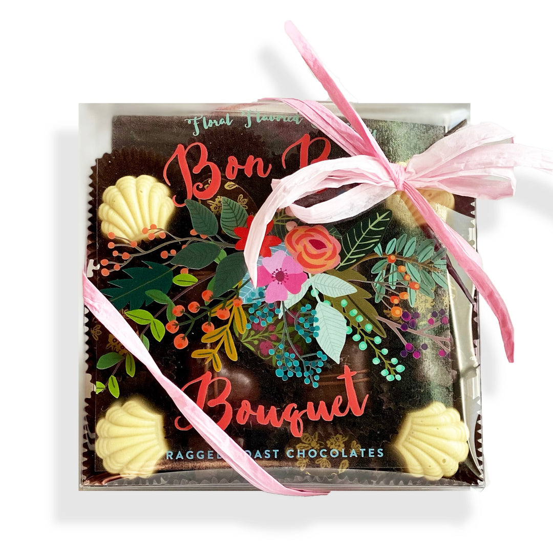 package of 17 handmade confections, flavored with culinary blossoms, wrapped in a pink ribbon on a white background.