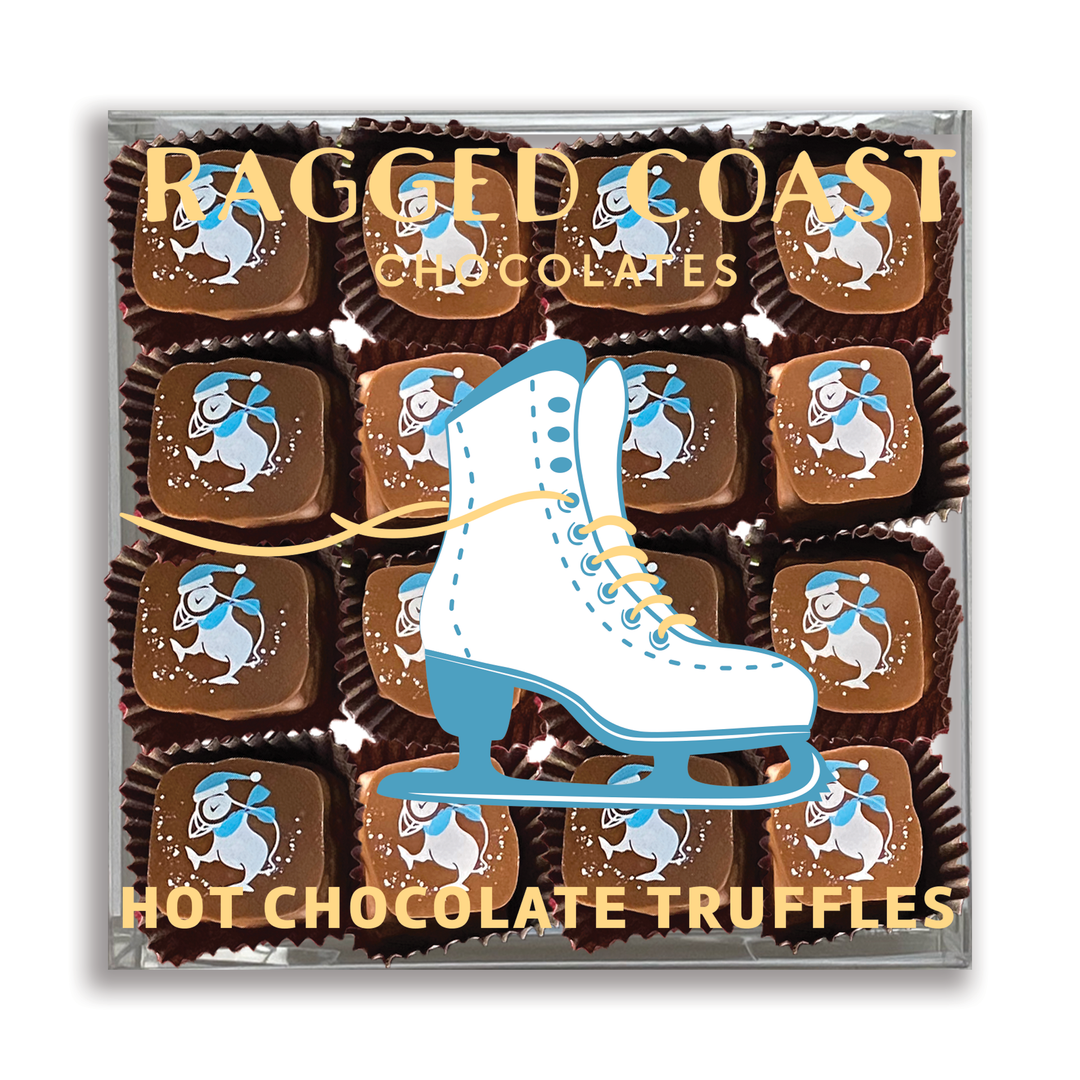 A package of Ragged Coast "Hot Chocolates" for the Holidays is showcased, featuring figure skating illustrations and elegant decorative packaging. The sumptuous chocolate ganache inside harmonizes beautifully with optional marshmallow fluff for a delightful treat.